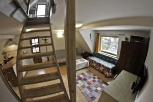a staircase leading up to a room with a bed at Chata Apart in Zakopane