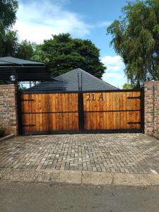 a wooden gate with the words zarma on it at 21on2nd Avenue in Tzaneen