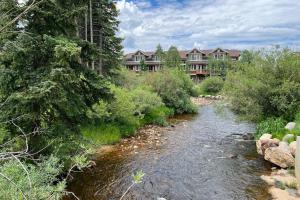 a river in front of a resort with a building at The Sanctuary Bldg 5 #7-8 in Winter Park