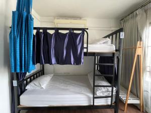 a bunk bed room with two bunk beds in it at Bake Room Hostel in Chiang Mai