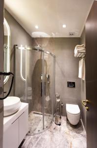 a bathroom with a shower and a toilet and a sink at Costera Hotel in Istanbul