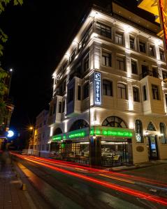 a lit up building on a street at night at Costera Hotel in Istanbul