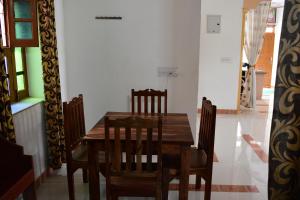 a dining room with a wooden table and chairs at Poonam Palace near by Airport in Jodhpur