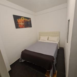 a small white bedroom with a bed in it at Rooms Moncloa in LOFT - TPH Madrid in Madrid