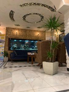 a lobby with a large flat screen tv and furniture at Mas-wadi in Aqaba