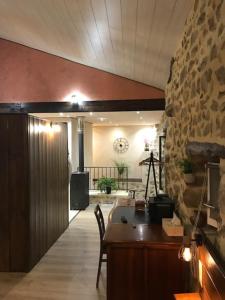 a room with a desk and a stone wall at Chez Marinou in Chirols