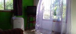 Zimmer mit einem Fenster mit einem weißen Vorhang in der Unterkunft casa de ensueño in La Falda + 16 Fotos