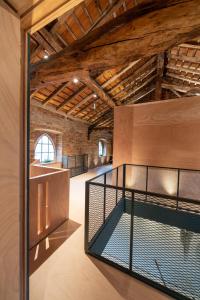 Agriturismo Padernello في Borgo San Giacomo: غرفة كبيرة مع كشك للخيول في مبنى