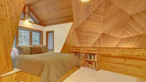 a bedroom with a bed in a wooden cabin at Cedar Creek Hideaway - Meredith Lodging in Welches