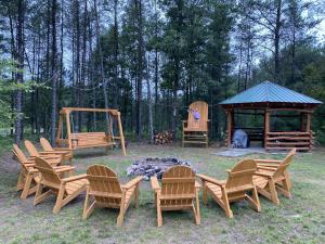 a group of chairs and a fire pit with a gazebo at #7 Brand New Castle Rock Lake 4 bedroom Lodge House in Friendship