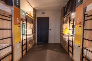 a room with bunk beds and a hallway at Whoo Bordeaux Bacalan - Hostel in Bordeaux