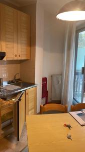 a kitchen with a counter and a table with chairs at Monolocale Artesina sci ai piedi in Sella della Turra