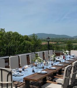 a long wooden table and chairs on a patio at Despot apartmani in Mladenovac