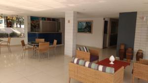 a living room with a table and chairs at Praia dos Carneiros Flat Hotel Fantástico in Tamandaré