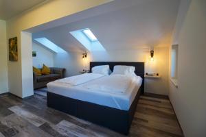 a bedroom with a large bed with a skylight at Haus Michael Tritscher in Schladming