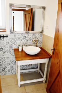 a bathroom with a sink and a mirror at R Cottage Jacuzzival in Balatonfenyves