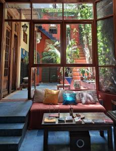 a living room with a couch and a large window at Boutique Hotel Casa Rugantino in Buenos Aires