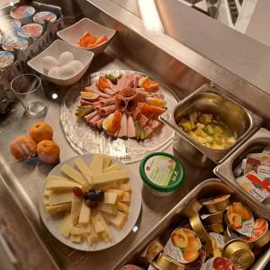 a counter with many plates of food on it at Hotel Pamakin in Wynau