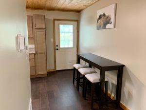 a room with a table with stools and a door at High Valley Apartments in Pigeon Forge