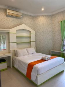 a bedroom with a large white bed in a room at Omah Ngangeni by OTSCA in Ngabean