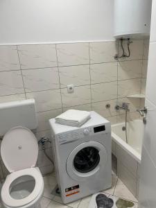 a bathroom with a washing machine and a toilet at OPTIMUM 1 apartment - One bedroom - in core city center in Zenica