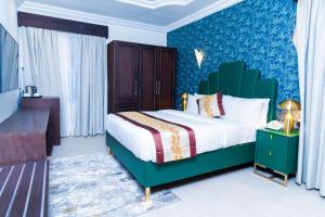 a bedroom with a bed and a blue wall at Terraform Hotel in Lagos +37 photos