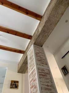 a stone wall in a room with wooden beams at Casa Chus in Albarracín