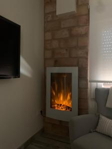 a fireplace in the corner of a living room at Casa Chus in Albarracín