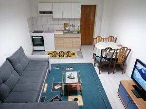 a living room with a couch and a table at Apartman Vuk in Pale