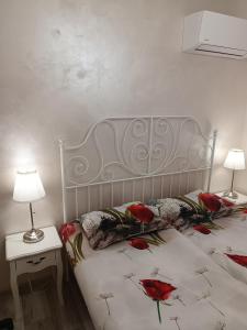 a bedroom with a bed with red roses on it at Апартамент 3 А in Varna City