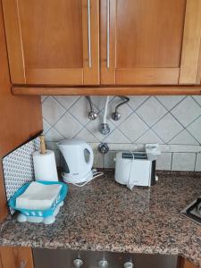 a kitchen with a counter top with appliances on it at Studio acolhedor e confortável - Nazaré Waves in Nazaré