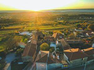 an aerial view of a house with the sunset in the background at Home Dren in Prepotto
