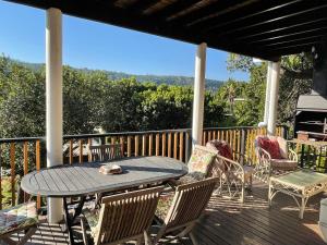 a patio with a table and chairs on a deck at Apartment Downstairs Sedgefield in Sedgefield
