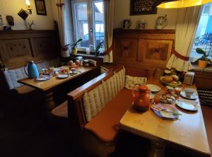 a dining room with a table with food on it at Landhaus Graßmann in Piding