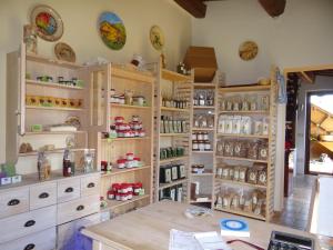 a kitchen with wooden cabinets and shelves at Agriturismo La Svolta in Manciano