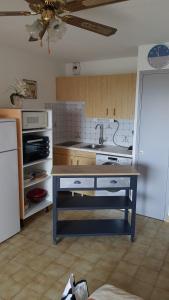 a kitchen with a table in the middle of it at Bel appart saint clair-lavandou in Le Lavandou