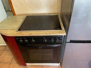 a stove top oven in a kitchen next to a refrigerator at Apartment Downstairs Sedgefield in Sedgefield