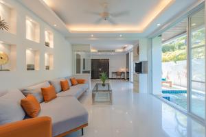 uma sala de estar com um sofá e uma mesa em White Villa Patong em Praia de Patong