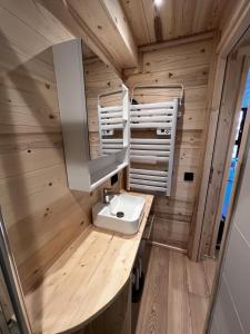 a bathroom with a sink in a tiny house at Les appartements Makalu Val Thorens in Val Thorens