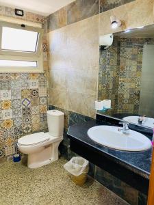 a bathroom with a toilet and a sink at Eel garden paradise dahab in Dahab +39 photos