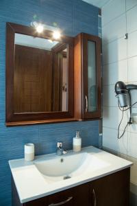 a bathroom with a sink and a mirror at Meteora Olio Hills apartment in Kalabaka