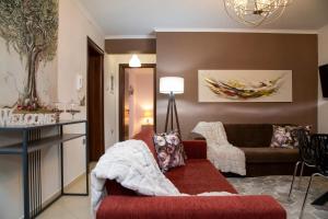 a living room with a couch and a table at Meteora Olio Hills apartment in Kalabaka