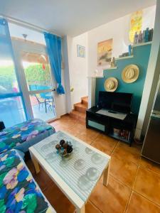 a living room with a table and a couch at Sun Dream Bungalow in San Bartolomé