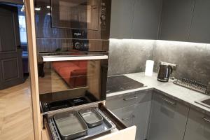 Kuchyňa alebo kuchynka v ubytovaní Apartament Wołodyjowskiego + 34 fotografií