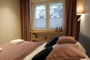 Posteľ alebo postele v izbe v ubytovaní Apartament Wołodyjowskiego