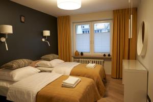 Posteľ alebo postele v izbe v ubytovaní Apartament Wołodyjowskiego
