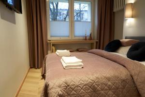 Posteľ alebo postele v izbe v ubytovaní Apartament Wołodyjowskiego