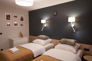 Posteľ alebo postele v izbe v ubytovaní Apartament Wołodyjowskiego