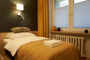 Posteľ alebo postele v izbe v ubytovaní Apartament Wołodyjowskiego