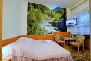 a bedroom with a large painting of a river at Pokoje Gościnne w Centrum in Szczyrk